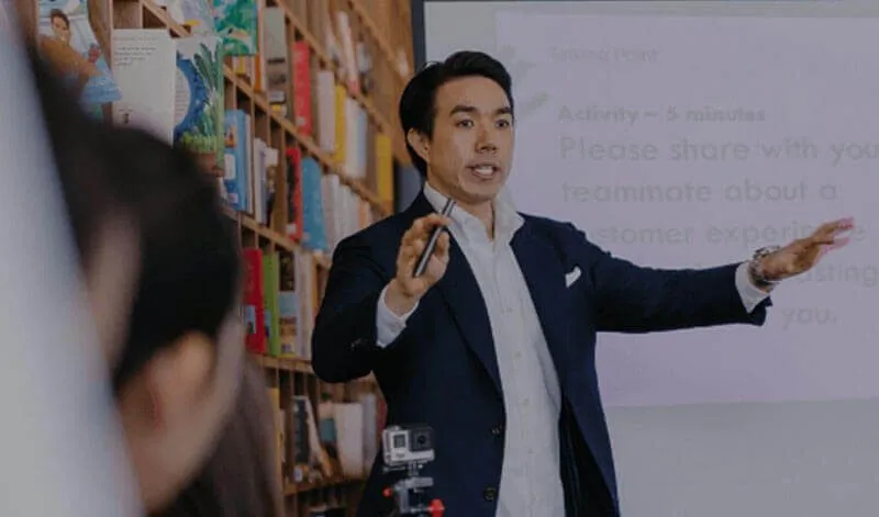A teacher presents to a class in a school library